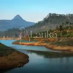 Mountain Adam's Peak at sunset with reflection in the lake. Sri Lanka