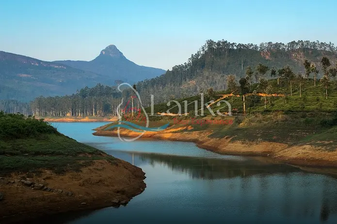 Mountain Adam's Peak at sunset with reflection in the lake. Sri Lanka